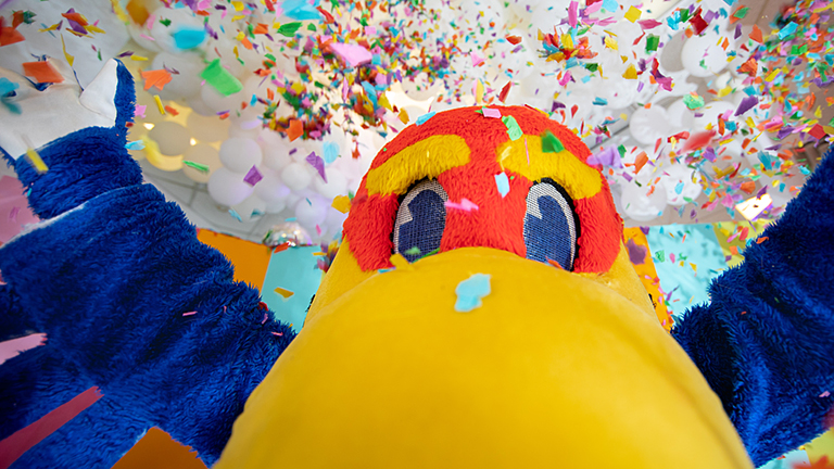 The University of Kansas Jayhawk Mascot with confetti