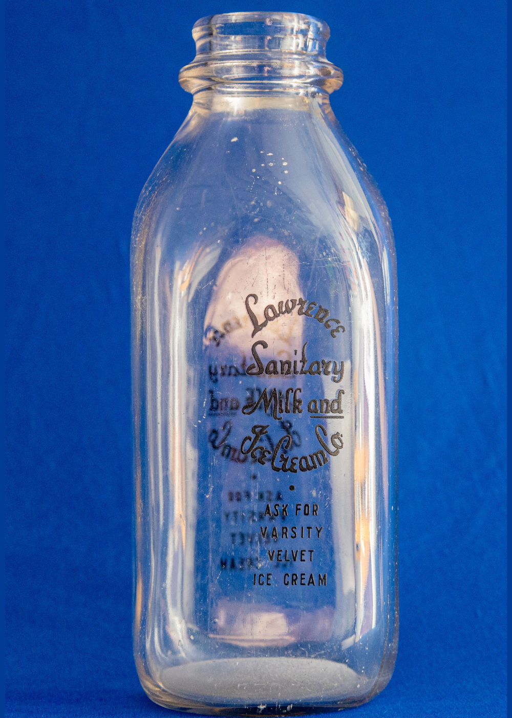 glass milk bottle labeled as Lawrence Sanitary Milk and Ice Cream Co. 