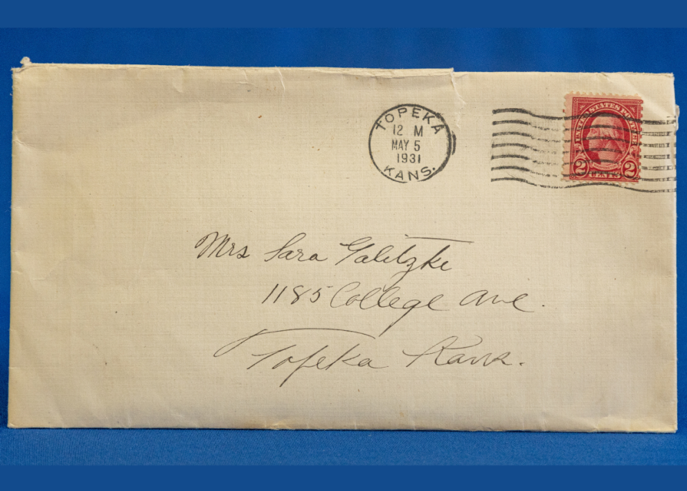 envelope with address and postmark, with a red stamp in the upper right corner